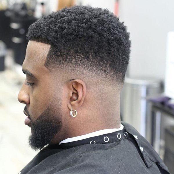 Blowout Taper Fade Haircut for Black Men with Curls
